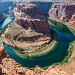 Not part of the Grand Canyon Nat'l Park. It begins 15 miles downstream from here. Horseshoe Bend is an iconic view of the Colorado River about one mile from Page, Az.  The overlook is about ¾ mile from a sand parking area. Be careful — there are no guardrails the overlook.    (9424)