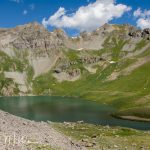 Almost surrounded by mountains, with lake runoff at the lower right.