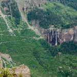 The switchbacks of the dangerous Black Bear Pass Trail. Also pictured, Bridal Veil Falls which plunge 365'. A power station, known as the Bridal Veil Powerhouse, was constructed in 1907 and was one of the first hydroelectric plants in the United States. It played a crucial role in continuing to provide electricity to the surrounding areas, including the mining operations in Telluride. From Imogene Pass Trail.