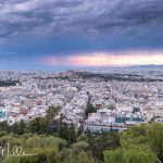 A portion of Athens from an elevated and commanding view. Looks southwest with the Acropolis centered in the photo, but far away. According to one source, just over 3 million people live in the Athens metro area, which extends for miles in every direction. Dense neighborhoods climb the surrounding hills and stretch to the coast. One out of three Greeks live in the Athens metro area. (3045)