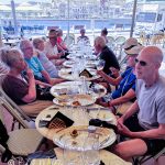 After climbing and descending many steps, we were treated to Greek wine and snacks at one of many restaurants on the harbor. (3885)